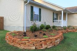 curving natural stone planting bed 
