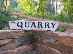 The road to the quarry is marked by a retaining wall and monument.