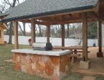 stone veneer grill table and covered patio