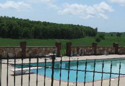 poolside natural ozark stone wall with red brick accents