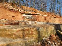 Sandstone is laid down horizontally in layers of varying thickness.